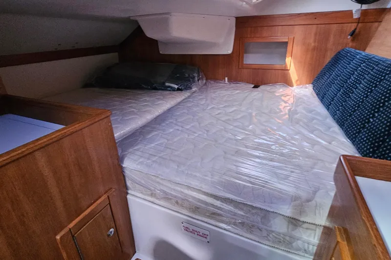 Slide: The Image of Interior cabin of a 2007 Catalina 350 sailboat with a double bed. - 25