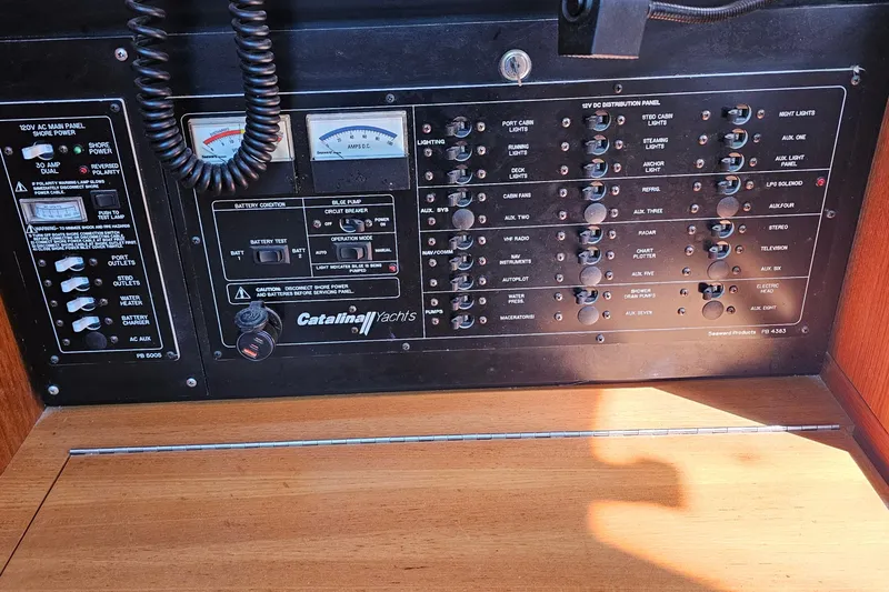 Slide: The Image of Control panel of a 2007 Catalina 350 yacht with various switches and gauges. - 28