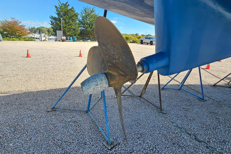 Slide: The Image of Catalina 350 sailboat propeller and keel on stands, 2007 model, in a boatyard. - 3