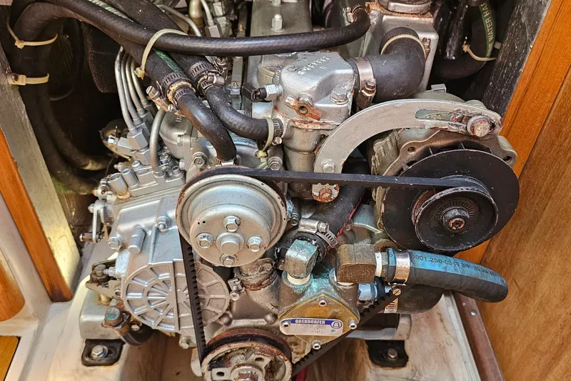 Slide: The Image of Engine of a 2007 Catalina 350 sailboat, showcasing mechanical components and hoses. - 30