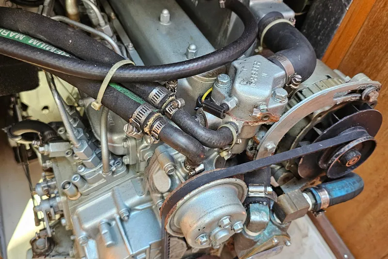 Slide: The Image of Engine of a 2007 Catalina 350 sailboat, showcasing detailed mechanical components. - 31