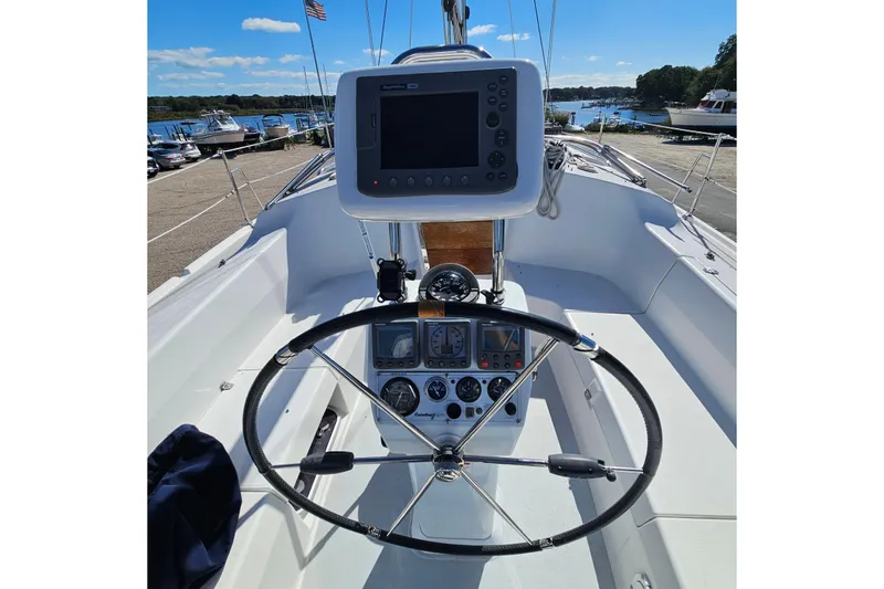 Slide: The Image of Cockpit of 2007 Catalina 350 sailboat with steering wheel and navigation instruments. - 4
