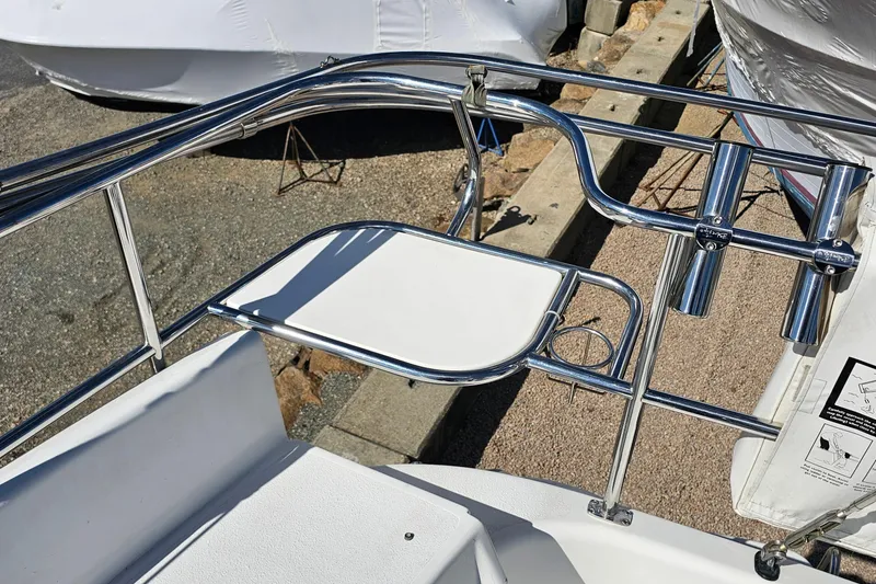 Slide: The Image of Stainless steel railings on a 2007 Catalina 350 boat deck, featuring rod holders and a foldable table. - 7