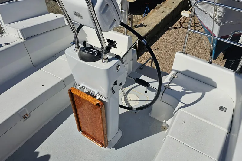 Slide: The Image of Cockpit of 2007 Catalina 350 sailboat with steering wheel and compass. - 8