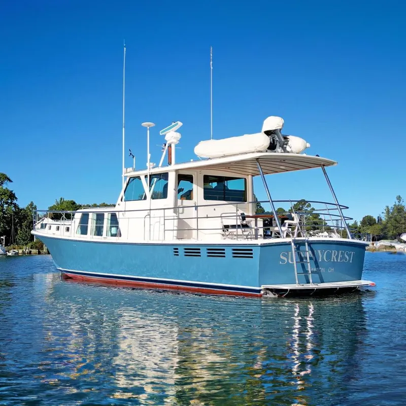 The Image of 2001 Dettling 51 yacht "Sunnycrest" on calm water under clear blue sky. - 0
