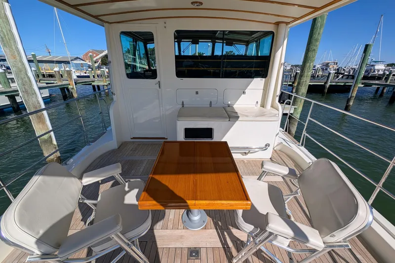 Slide: The Image of 2001 Dettling 51 yacht deck with table and chairs, docked at marina. - 12