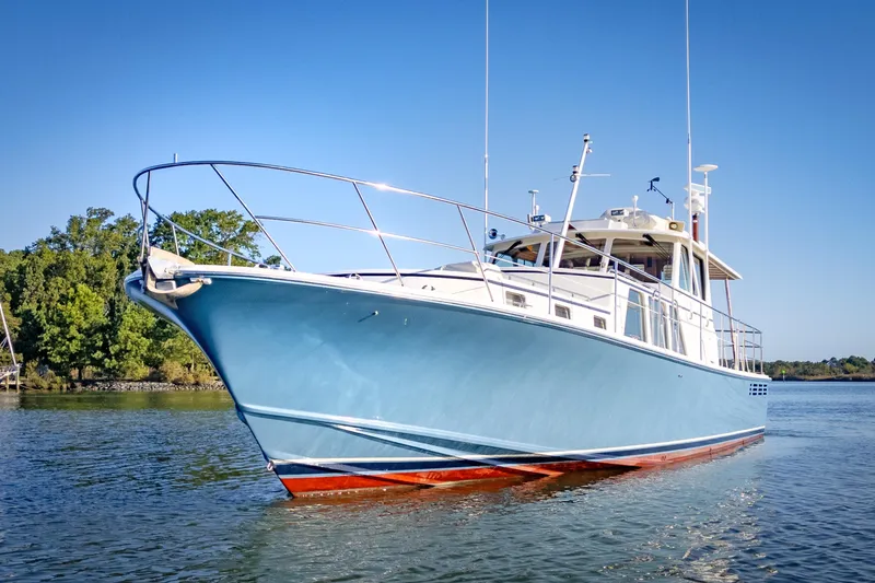 Slide: The Image of 2001 Dettling 51 yacht on calm water, clear sky background. - 2