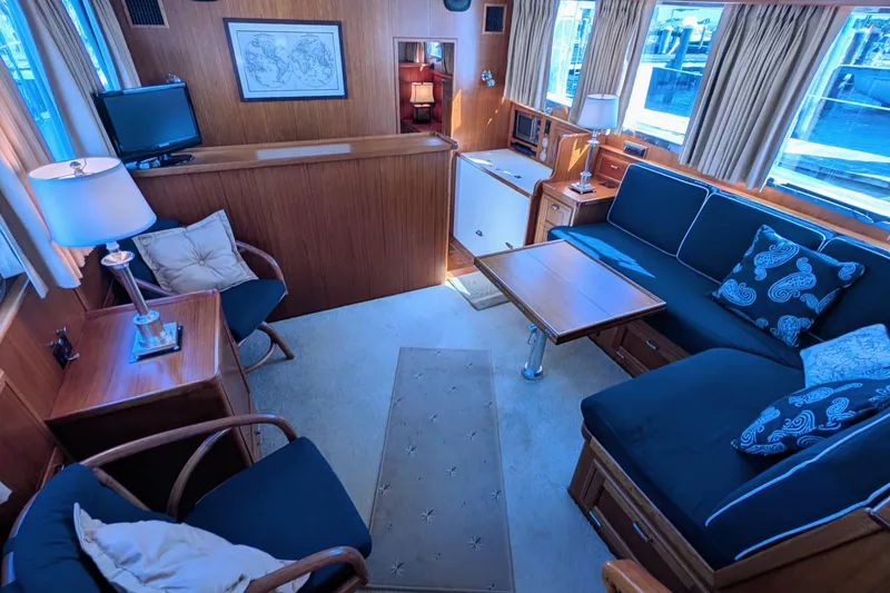 Slide: The Image of Luxurious interior of a 2001 Dettling 51 yacht with elegant wood paneling and cozy seating. - 23