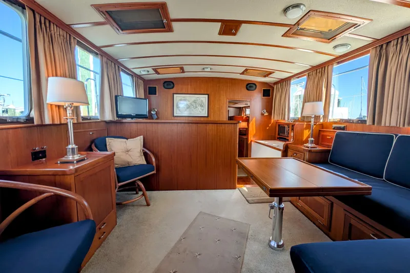 Slide: The Image of Luxurious interior of a 2001 Dettling 51 yacht with wood paneling and elegant furnishings. - 26