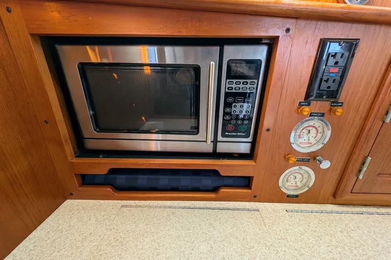 Slide: The Image of Built-in microwave and control panel in a 2001 Dettling 51 yacht kitchen. - 29