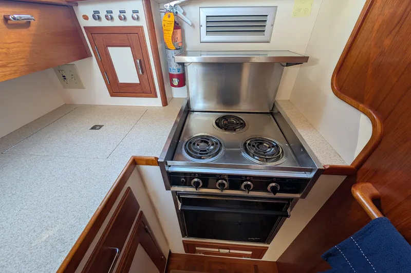 Slide: The Image of Compact kitchen area in a 2001 Dettling 51 yacht with stove and oven. - 31
