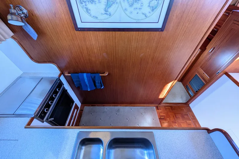 Slide: The Image of Interior of 2001 Dettling 51 yacht kitchen with wood paneling and stainless steel sink. - 33