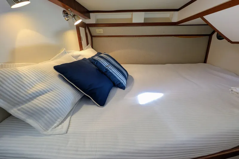 Slide: The Image of Cozy cabin bed with white and blue pillows in a 2001 Dettling 51 yacht. - 35