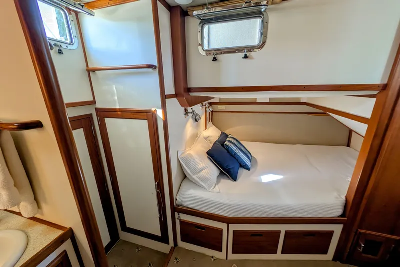 Slide: The Image of Cozy cabin interior of 2001 Dettling 51 yacht with bed and wooden accents. - 39