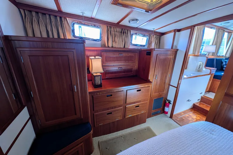 Slide: The Image of Luxurious wooden interior of a 2001 Dettling 51 yacht cabin with elegant furnishings. - 44