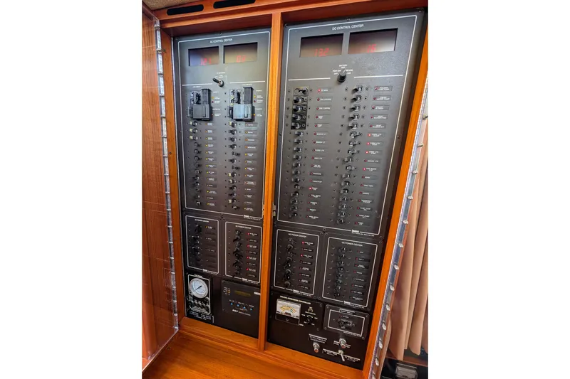 Slide: The Image of Electrical control panel of a 2001 Dettling 51 yacht, featuring switches and meters. - 49
