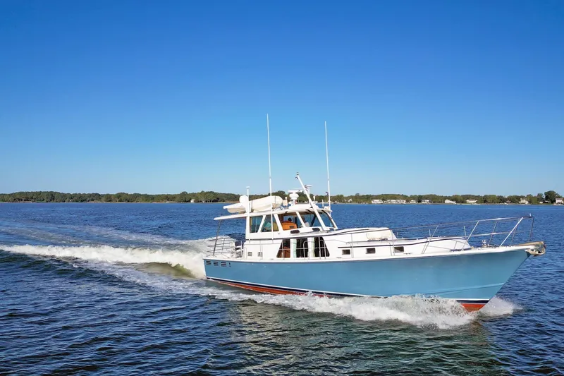 Slide: The Image of 2001 Dettling 51 yacht cruising on a clear blue lake under a sunny sky. - 5