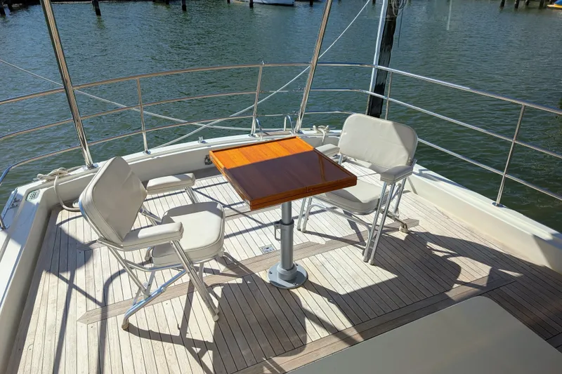 Slide: The Image of Deck of 2001 Dettling 51 yacht with chairs and table overlooking water. - 9