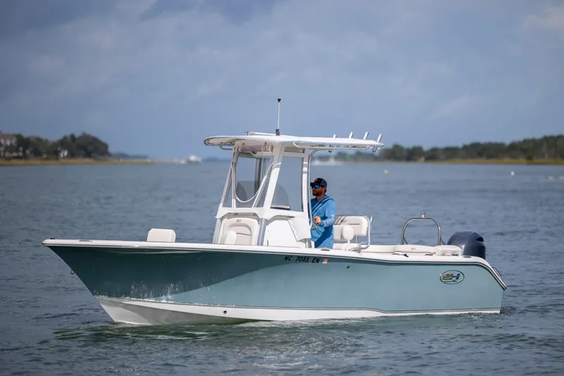 Slide: The Image of 2020 Sea Hunt Ultra 225 boat cruising on a calm waterway. - 0