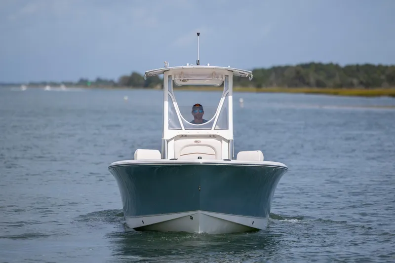 Slide: The Image of 2020 Sea Hunt Ultra 225 boat cruising on calm water. - 1