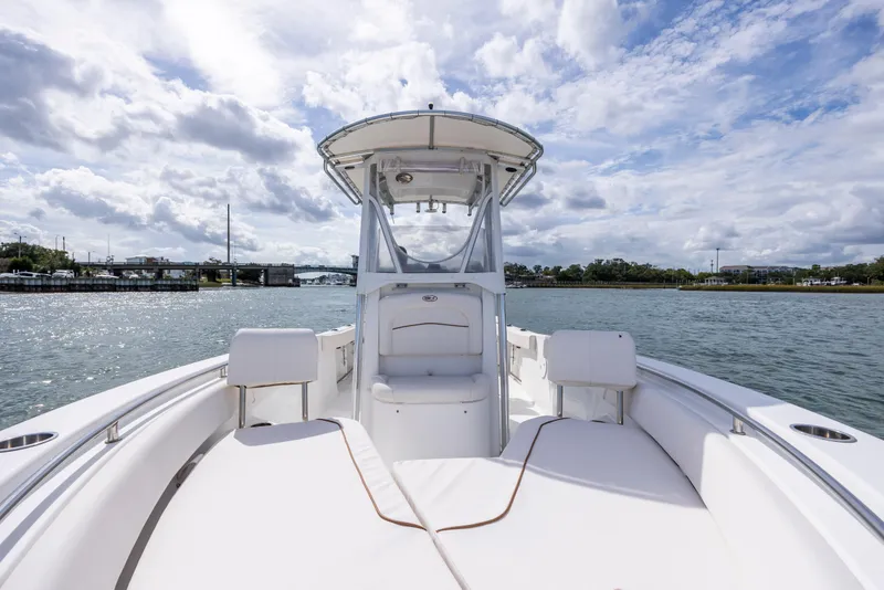 Slide: The Image of 2020 Sea Hunt Ultra 225 boat on water under cloudy sky. - 12