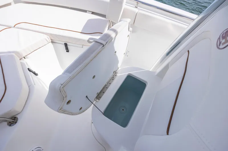 Slide: The Image of 2020 Sea Hunt Ultra 225 boat interior with open storage compartment. - 13