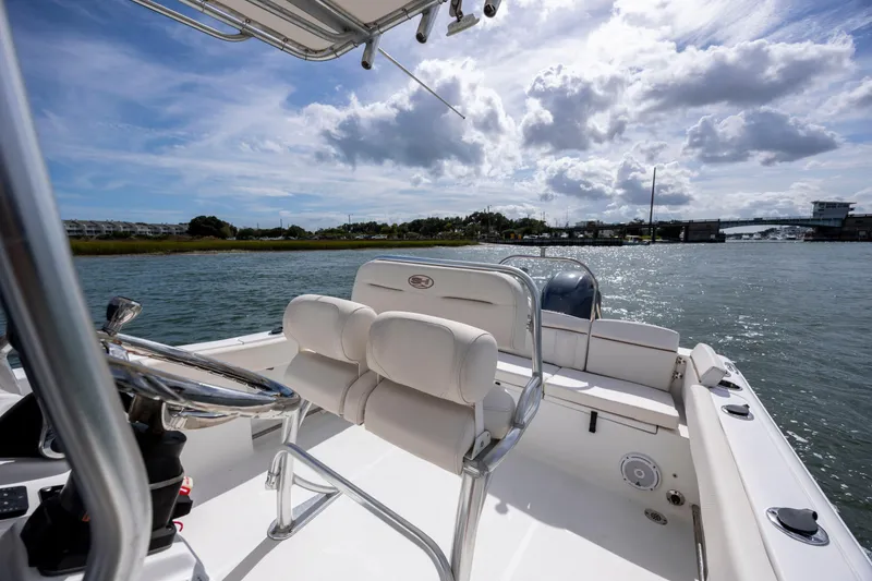 Slide: The Image of 2020 Sea Hunt Ultra 225 boat on water, sunny day, scenic view. - 14