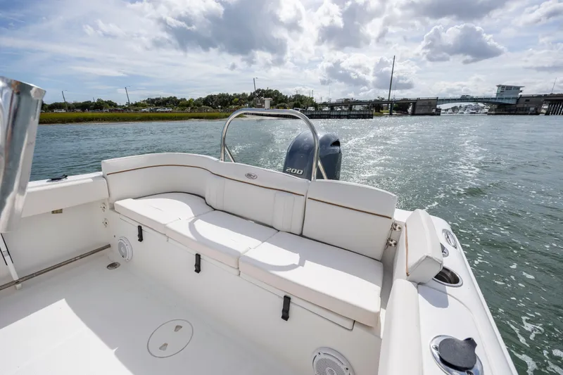 Slide: The Image of 2020 Sea Hunt Ultra 225 boat interior with seating, cruising on a sunny day. - 18