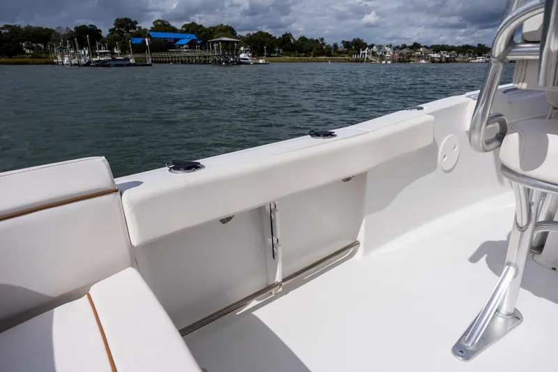 Slide: The Image of 2020 Sea Hunt Ultra 225 boat interior with white seating and water view. - 22