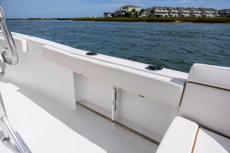 Slide: The Image of 2020 Sea Hunt Ultra 225 boat interior with water and buildings in the background. - 23