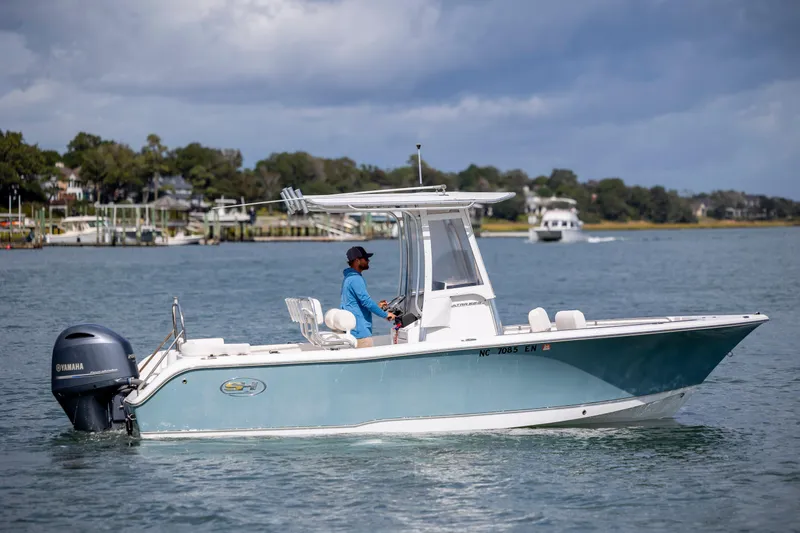 Slide: The Image of 2020 Sea Hunt Ultra 225 boat cruising on a calm waterway. - 4