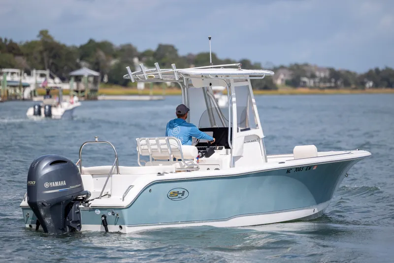 Slide: The Image of 2020 Sea Hunt Ultra 225 boat cruising on a calm waterway. - 5