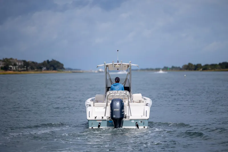 Slide: The Image of 2020 Sea Hunt Ultra 225 boat cruising on a calm waterway. - 6