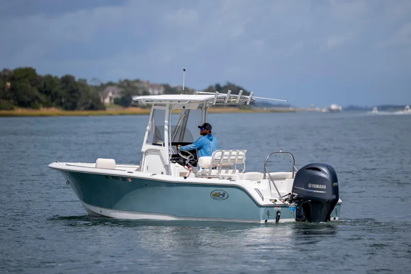 Slide: The Image of 2020 Sea Hunt Ultra 225 boat cruising on a calm waterway. - 7