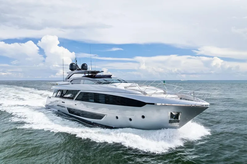 The Image of 2023 Riva 110' Dolcevita yacht cruising on open water under a cloudy sky. - 0