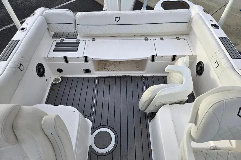 Slide: The Image of 2024 Sea Fox 228 Traveler boat interior with white seating and gray flooring. - 10