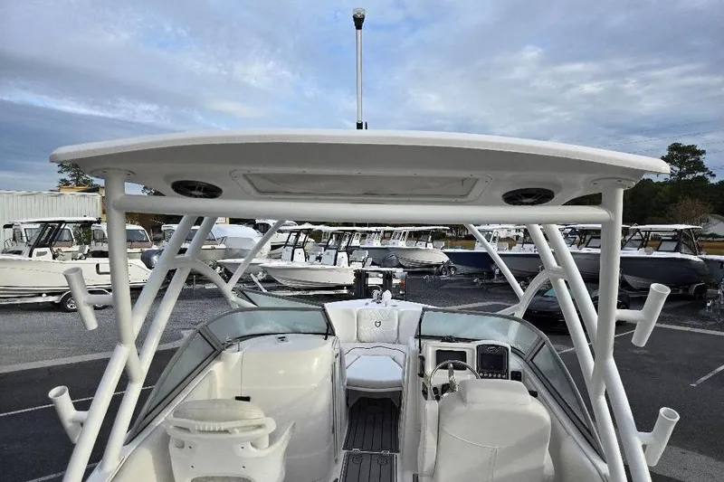 Slide: The Image of 2024 Sea Fox 228 Traveler boat with T-top, docked among other boats. - 12