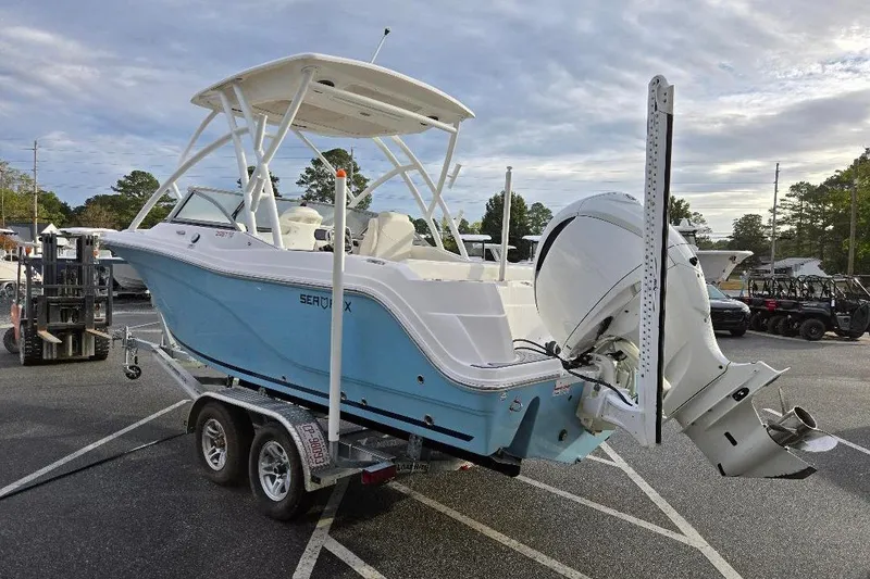 Slide: The Image of 2024 Sea Fox 228 Traveler boat on trailer, featuring sleek design and powerful outboard motor. - 4