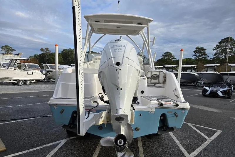 Slide: The Image of 2024 Sea Fox 228 Traveler boat with powerful outboard motor in a marina setting. - 5