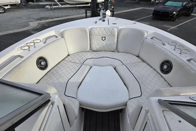 Slide: The Image of 2024 Sea Fox 228 Traveler boat interior with cushioned seating and cup holders. - 6
