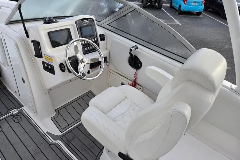Slide: The Image of 2024 Sea Fox 228 Traveler boat cockpit with steering wheel and white captain's chair. - 7