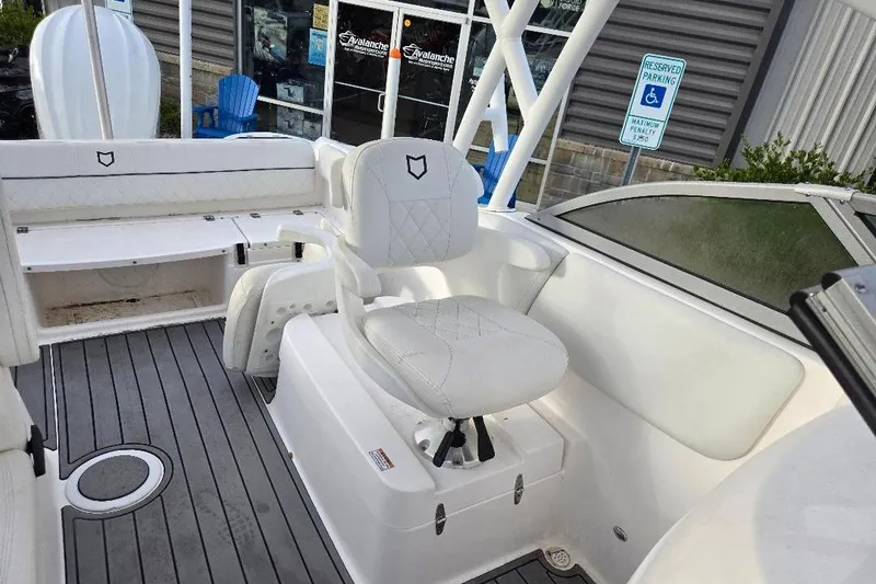 Slide: The Image of 2024 Sea Fox 228 Traveler boat interior with white seating and gray flooring. - 9