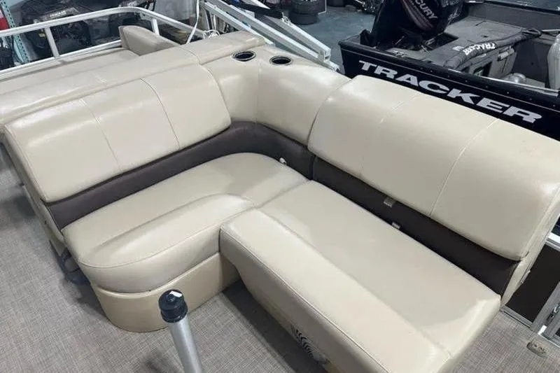 Slide: The Image of 2019 Sun Tracker Party Barge 22 RF DLX with beige seating and cup holders. - 11