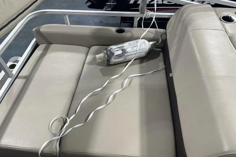 Slide: The Image of 2019 Sun Tracker Party Barge 22 RF DLX with beige seating and a boat fender. - 13