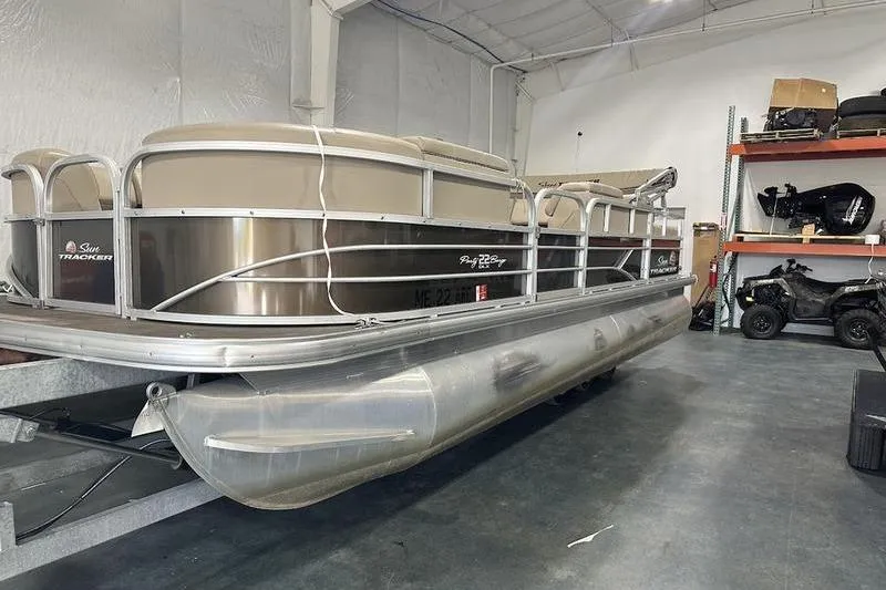 The Image of 2019 Sun Tracker Party Barge 22 RF DLX pontoon boat in a storage facility. - 2