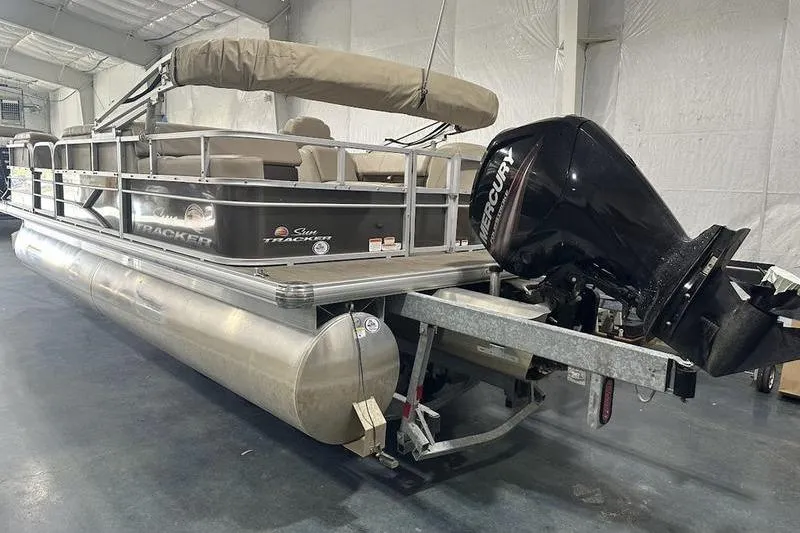 Slide: The Image of 2019 Sun Tracker Party Barge 22 RF DLX pontoon boat with Mercury outboard motor in a storage facility. - 5