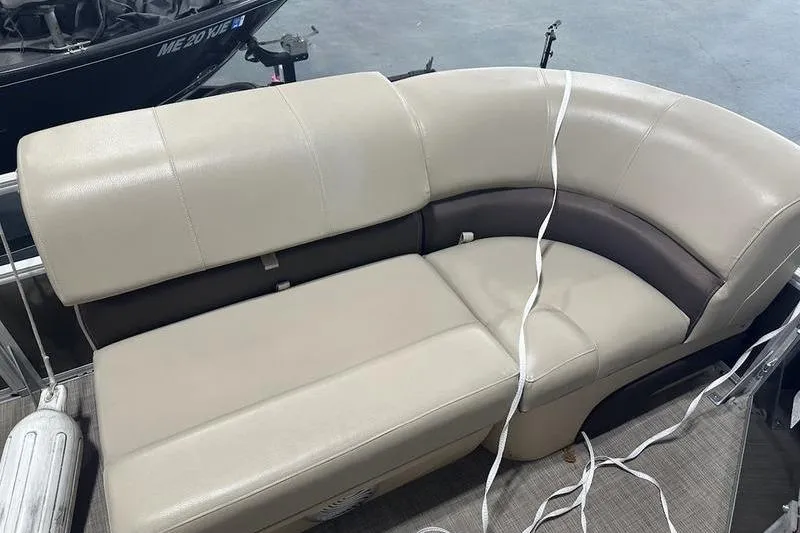 Slide: The Image of 2019 Sun Tracker Party Barge 22 RF DLX beige seating with white straps on a boat. - 7