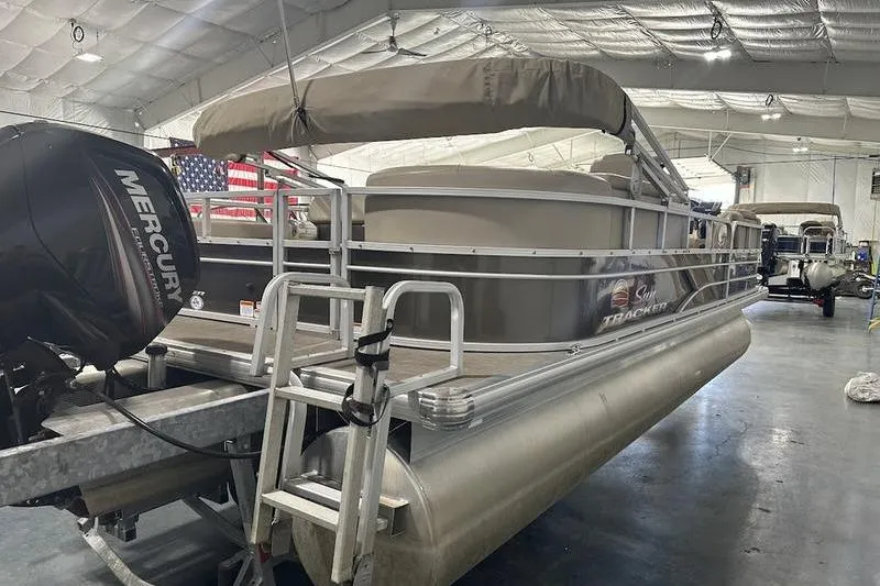 Slide: The Image of 2019 Sun Tracker Party Barge 22 RF DLX pontoon boat in indoor storage. - 9