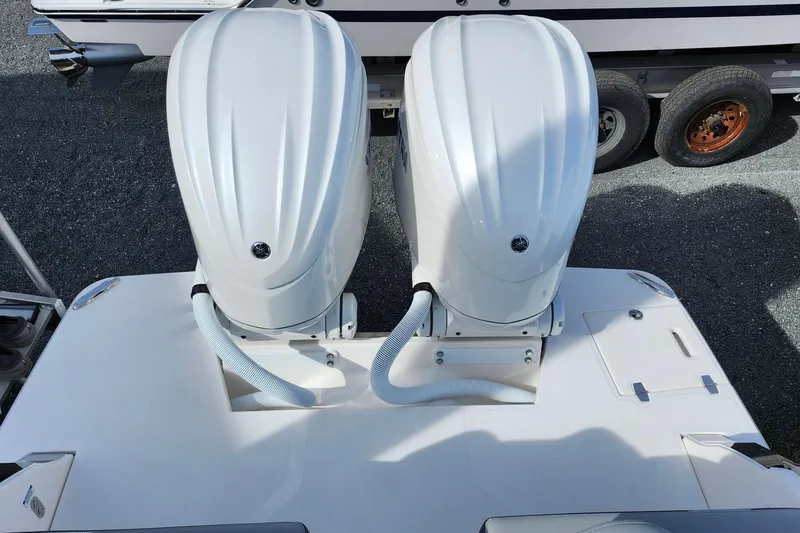 Slide: The Image of Twin outboard engines on a 2026 Regal LX9 boat, parked on a trailer. - 41