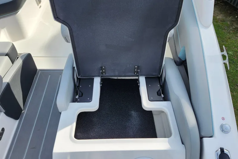 Slide: The Image of 2026 Regal LX9 boat seat storage compartment, open view, showcasing interior space. - 42